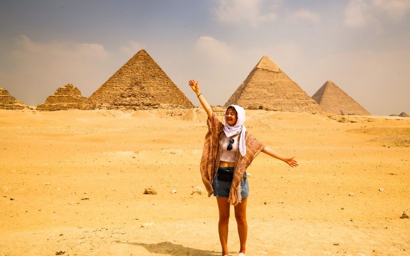 a-lady-enjoying-her-trip-in-egypt-around-the-pyramids-of-giza Planning a trip to Egypt