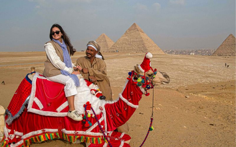 a-tourist-female-riding-a-camel-on-her-egypt-christmas-tour Egypt Christmas Tour